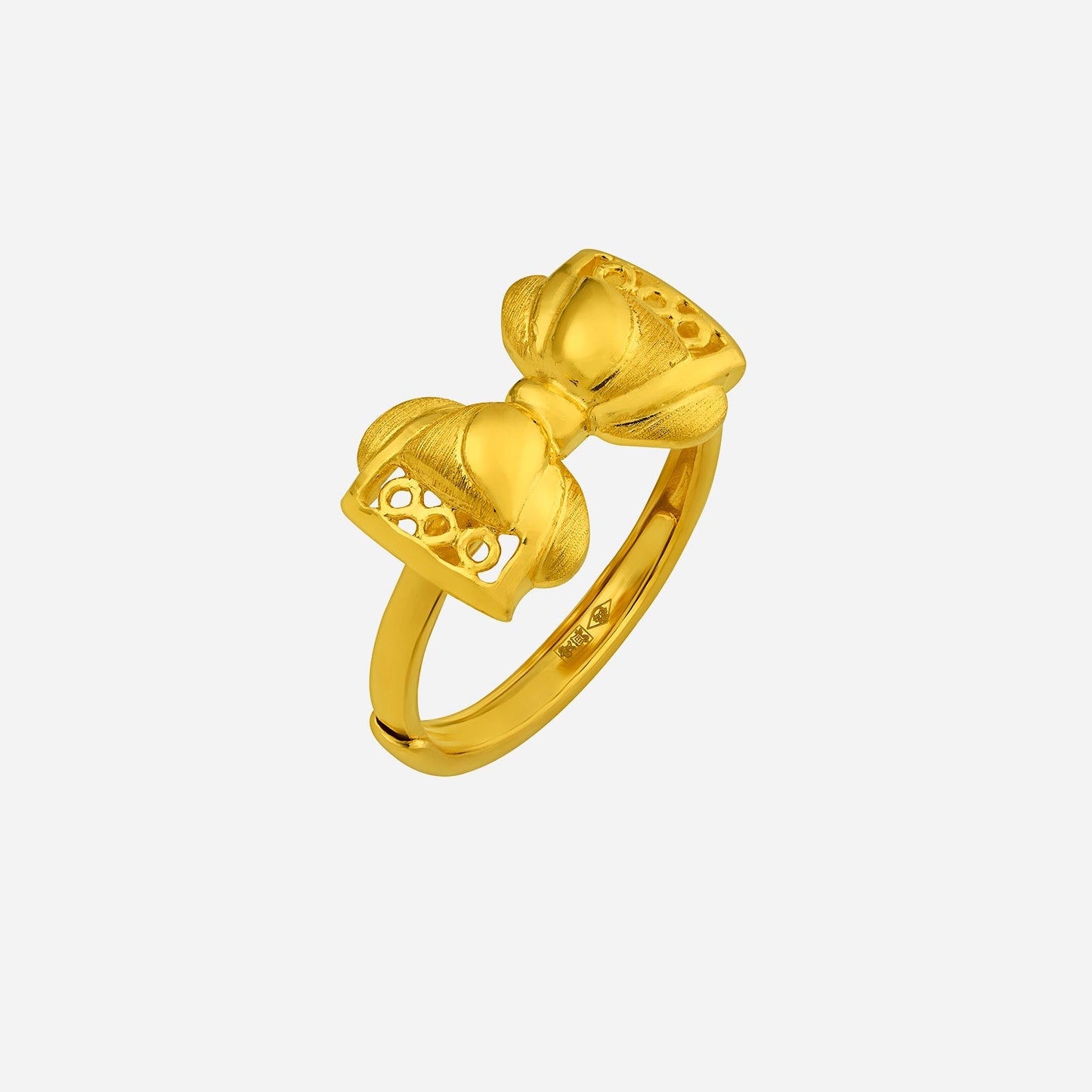 ribbon ring in 24k yellow gold with a textured bow design, showcasing elegance and playful charm.