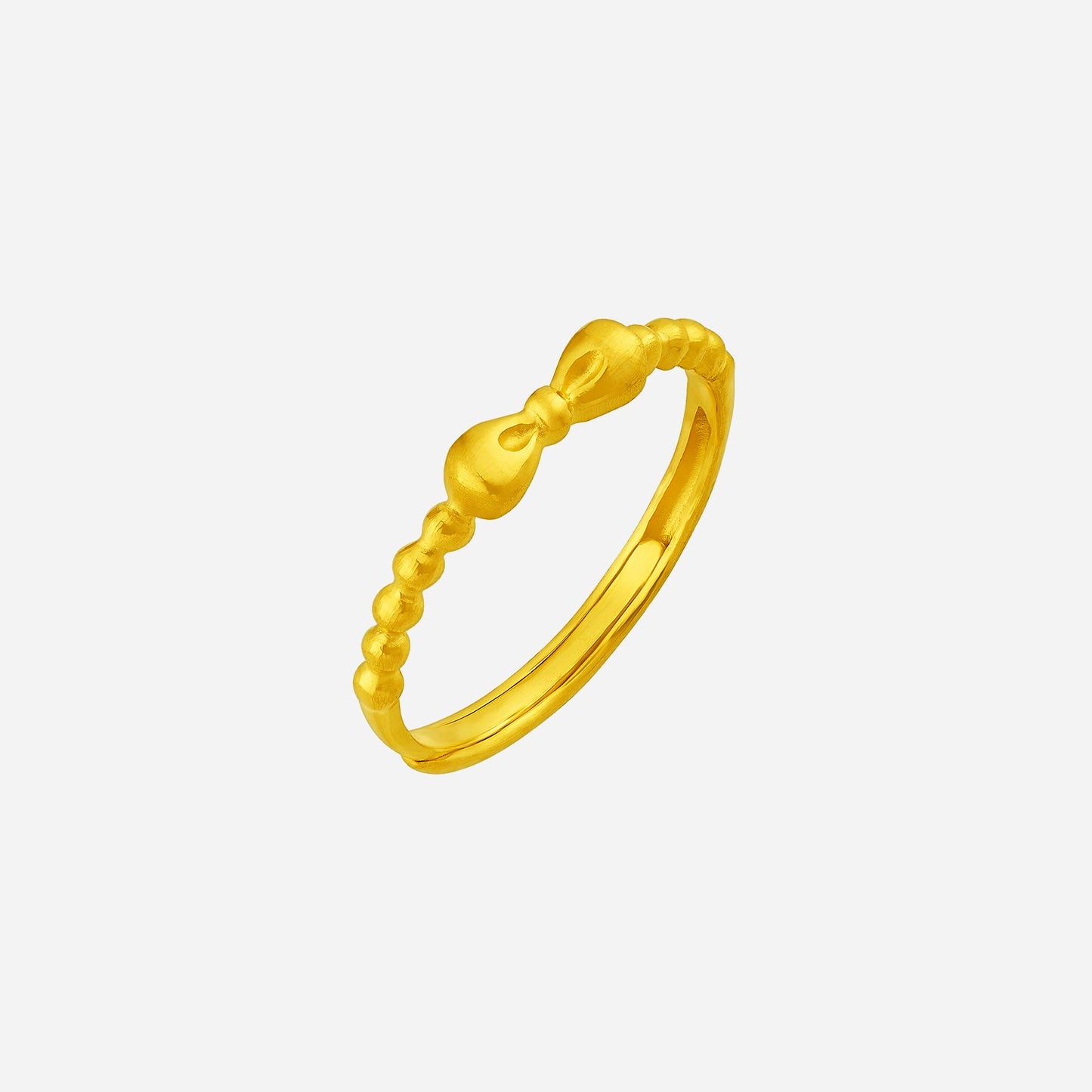 dainty ribbon ring in 24k yellow gold featuring a bow design with a textured band for a charming look.