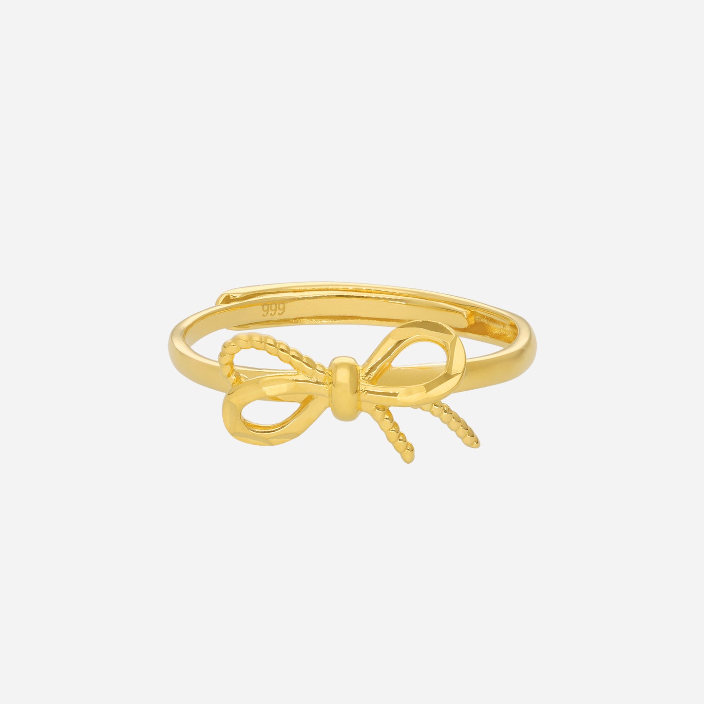 ribbon ring in 24k yellow gold with polished band and textured ribbon detail, symbolizing love and joy.