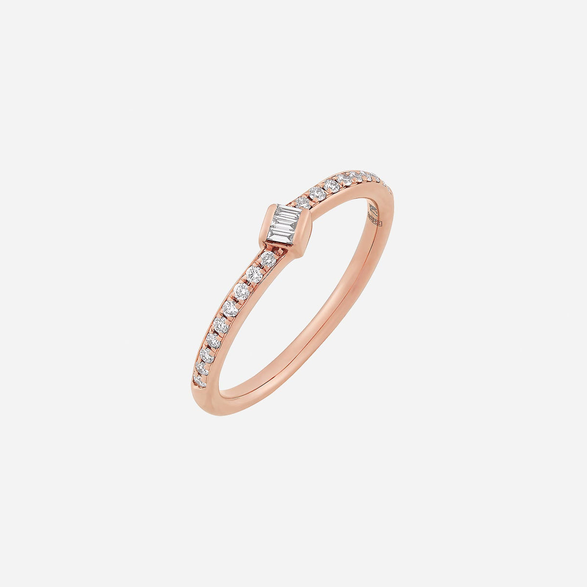 dainty rose gold diamond ring featuring a baguette center stone and pavé set band for a subtle hint of elegance.