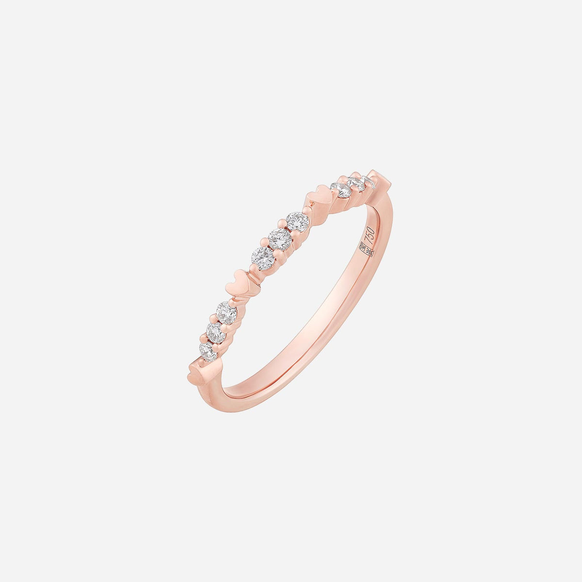 je t'aime diamond ring in 18k rose gold with heart-shaped accents and sparkling diamonds along the band.