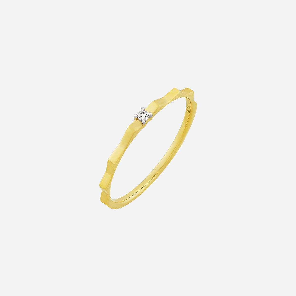 faceted diamond ring in 18k yellow and white gold with soft angular curves and single diamond accent.