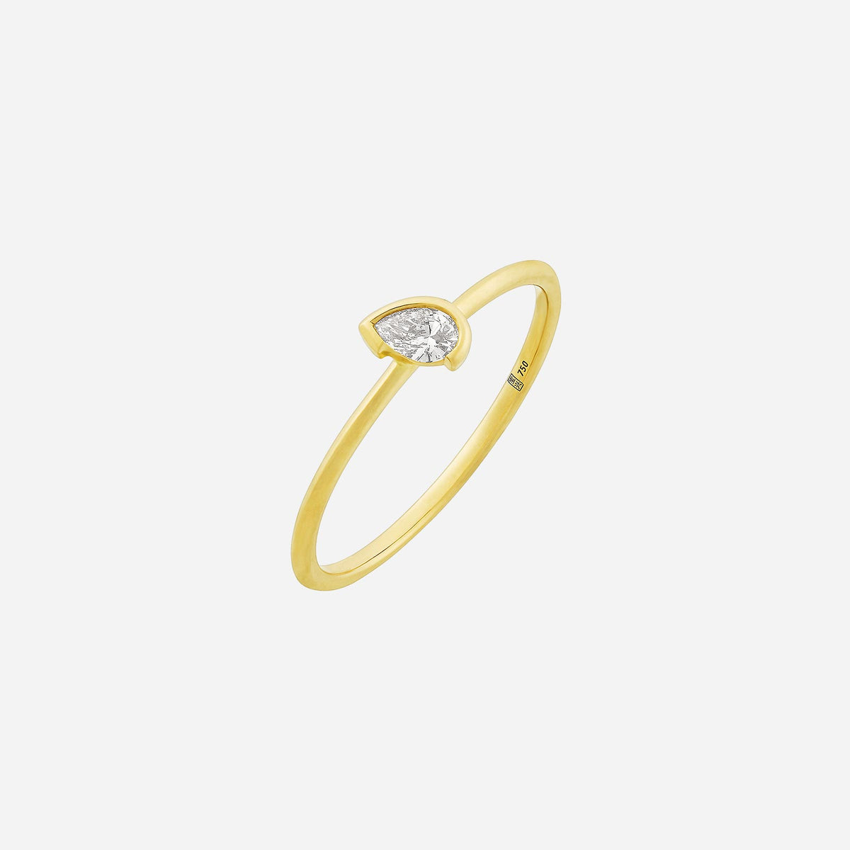 delicate 18k yellow gold ring featuring a tilted pear-shaped diamond on a fine band.