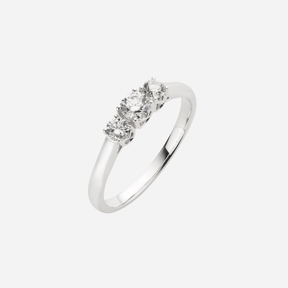 trilogy diamond ring in 18k white gold featuring a central diamond flanked by two smaller diamonds.