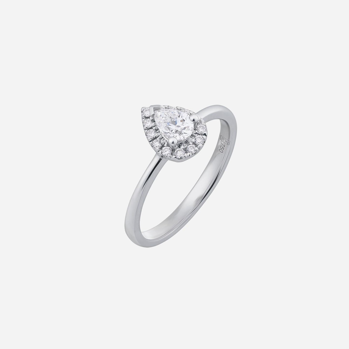 pear cut diamond ring in 18k white gold, featuring a halo of small sparkling diamonds around the center stone.