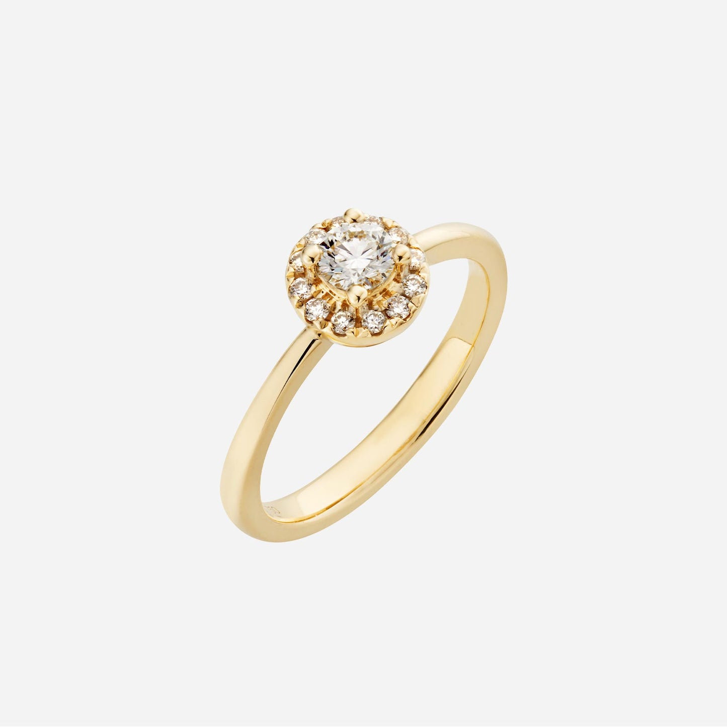 halo diamond ring in yellow gold featuring a round brilliant cut diamond and surrounding smaller diamonds in a halo design.