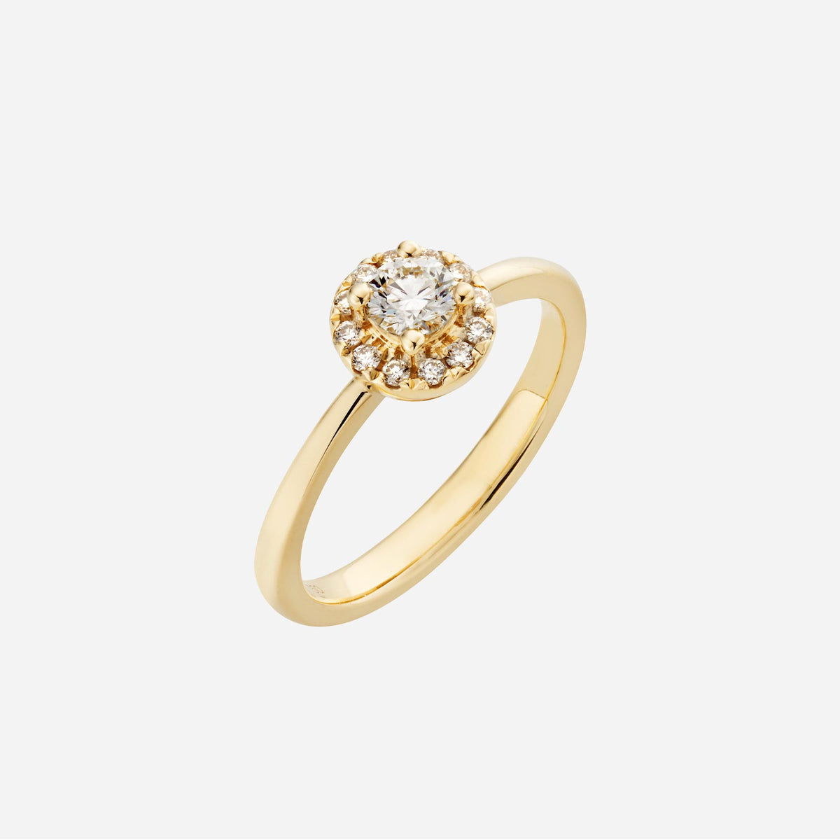halo diamond ring in 18k yellow gold featuring a round brilliant cut diamond and halo of small diamonds.