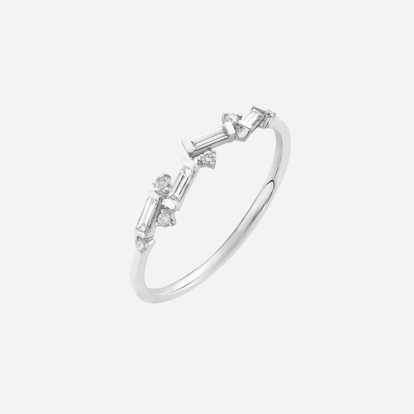 asymmetrical white gold ring featuring baguette and round diamonds for a modern, elegant look.