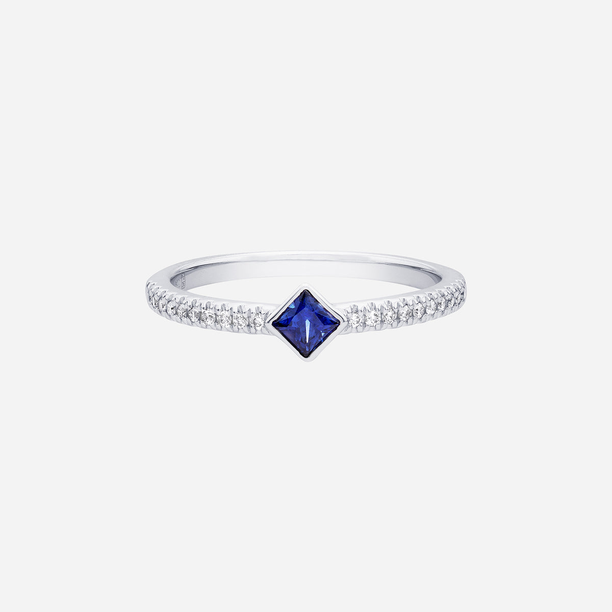 elegant blue sapphire ring in 18k white gold with a diamond-lined band and a square-cut sapphire centerpiece.