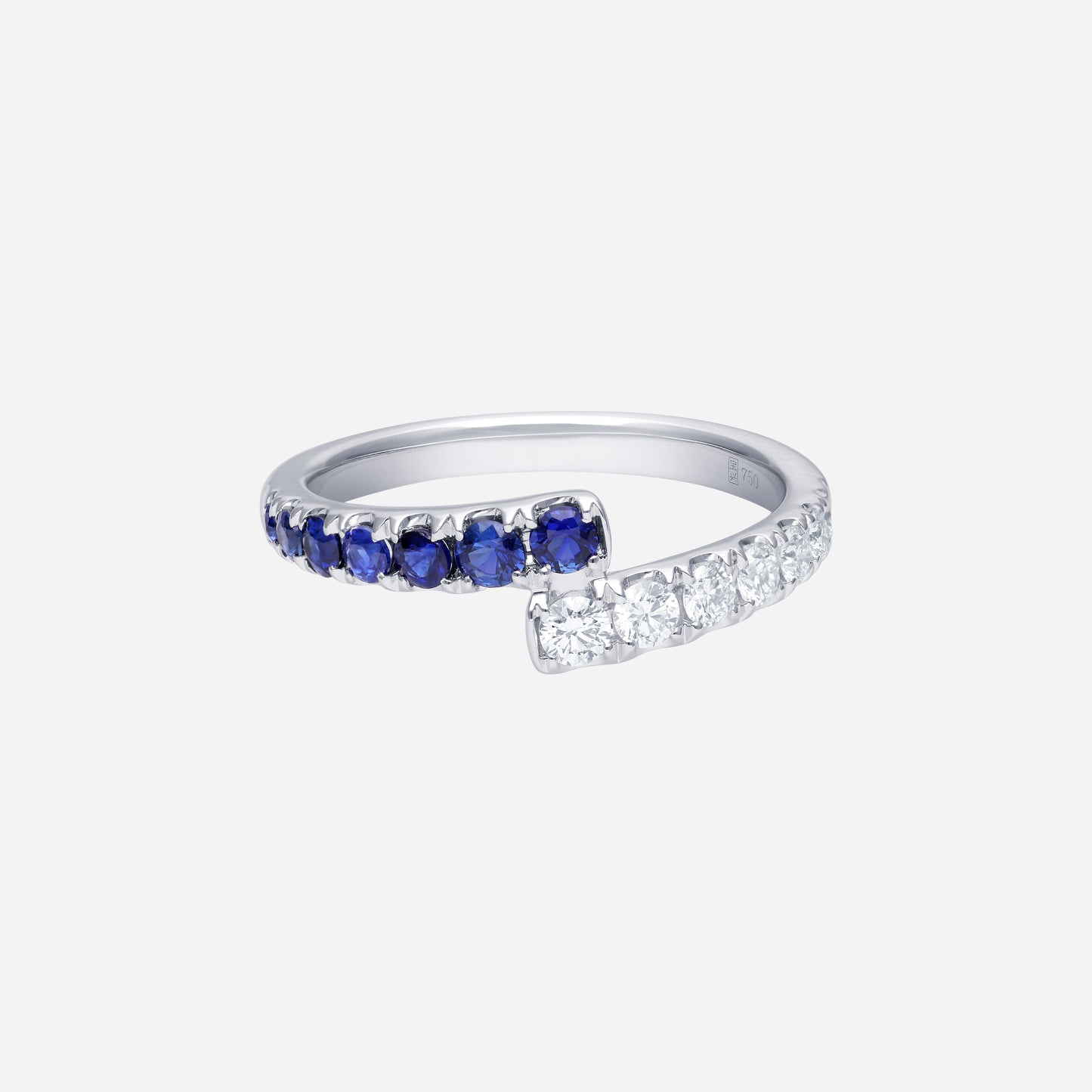 blue sapphire and diamond ring in 18k white gold, featuring a curved design with alternating deep-blue sapphires and sparkling diamonds.