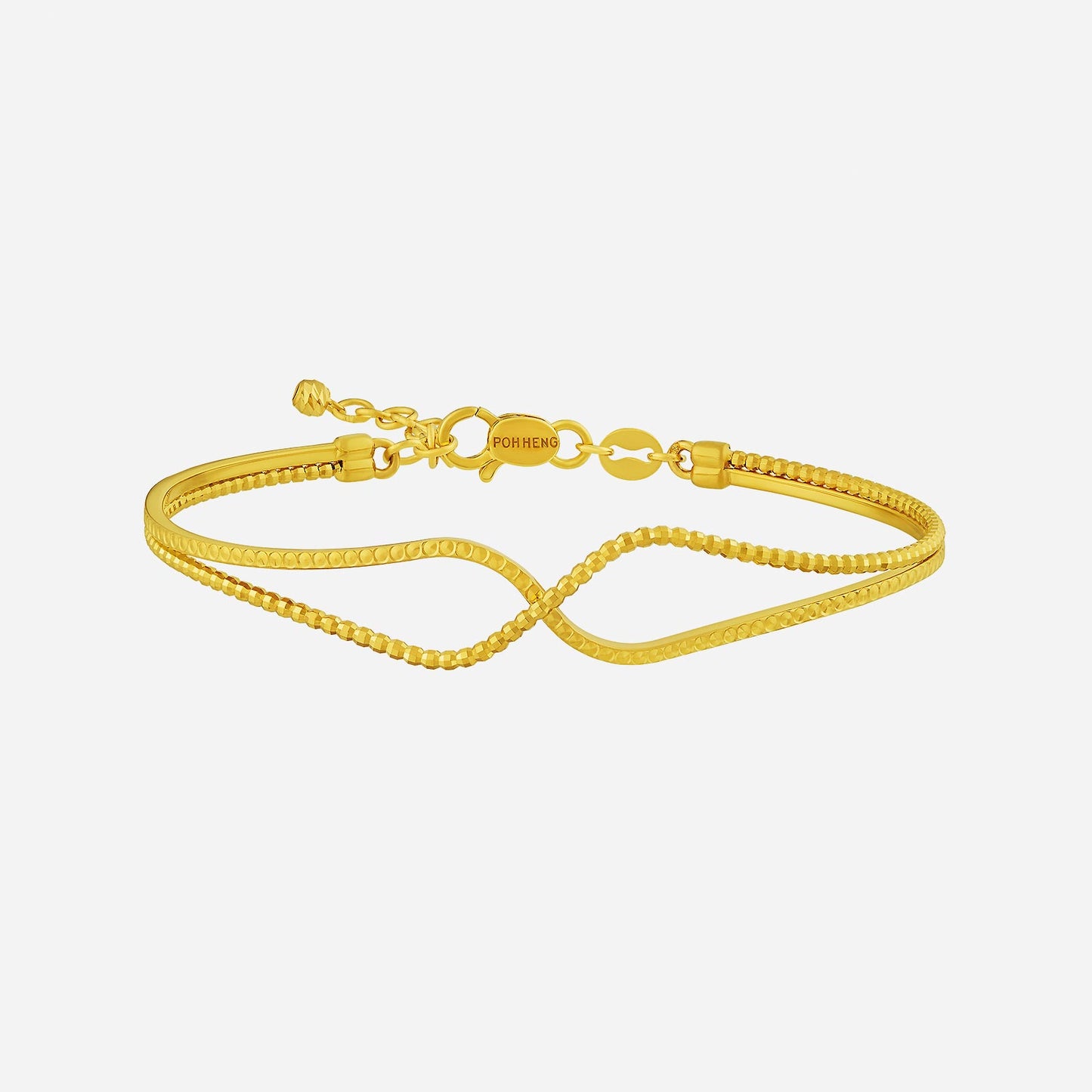 twisted bangle in 22k yellow gold with faceted textures and a fluid wave design for everyday elegance.