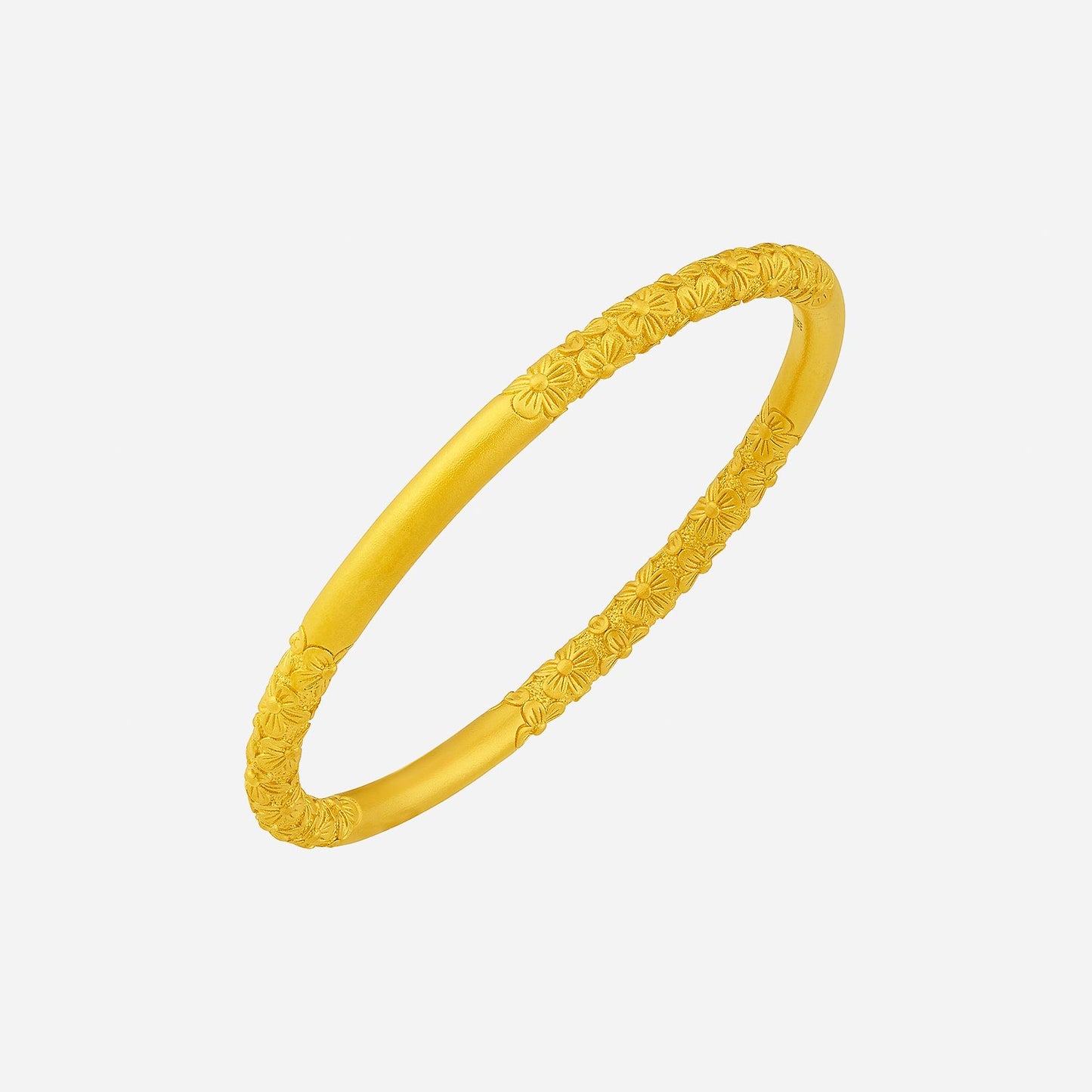 sleek 24k yellow gold bangle with floral engraving, combining modern elegance and traditional design details.