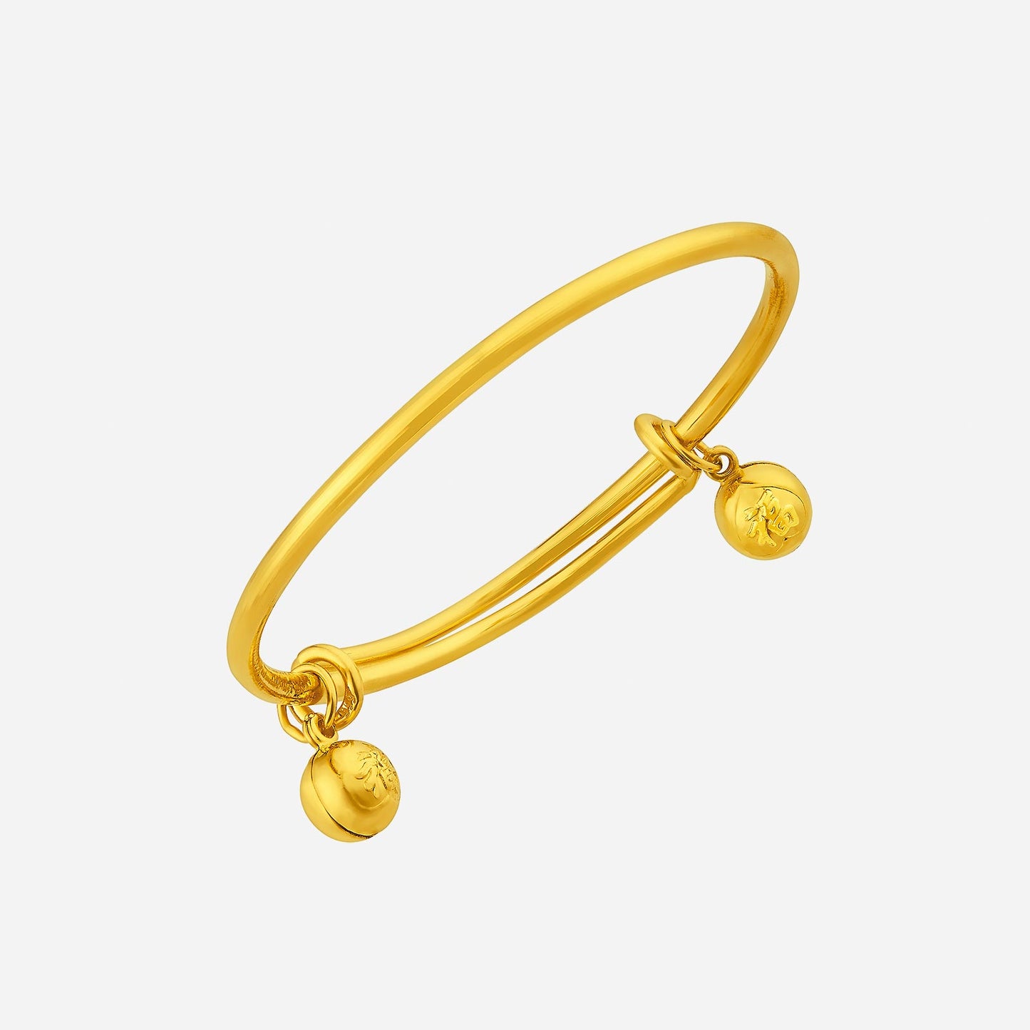 24k yellow gold baby bangle featuring delicate jingling charms, a timeless keepsake for childhood joy.