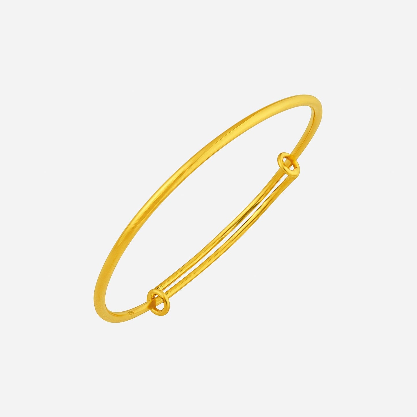 24k yellow gold bangle with a minimalist design and subtle knot detail, perfect for elegant occasions.
