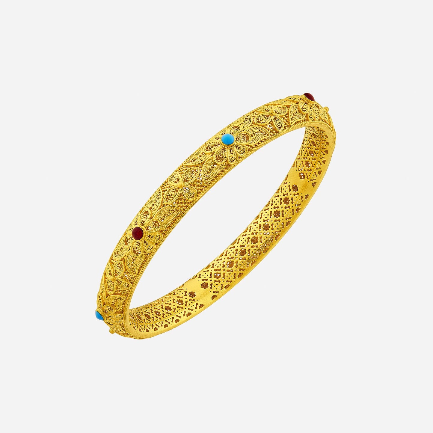24k yellow gold bangle featuring intricate filigree and colorful gemstones in red and blue accents. timeless luxury design.