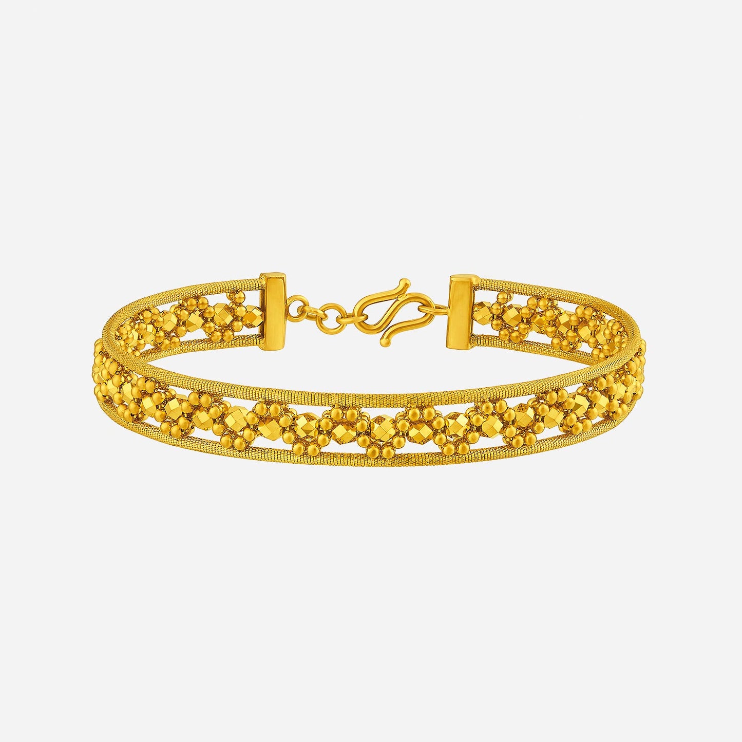 radiant bangle in 24k yellow gold with intricate openwork and polished bead accents for a luminous design.