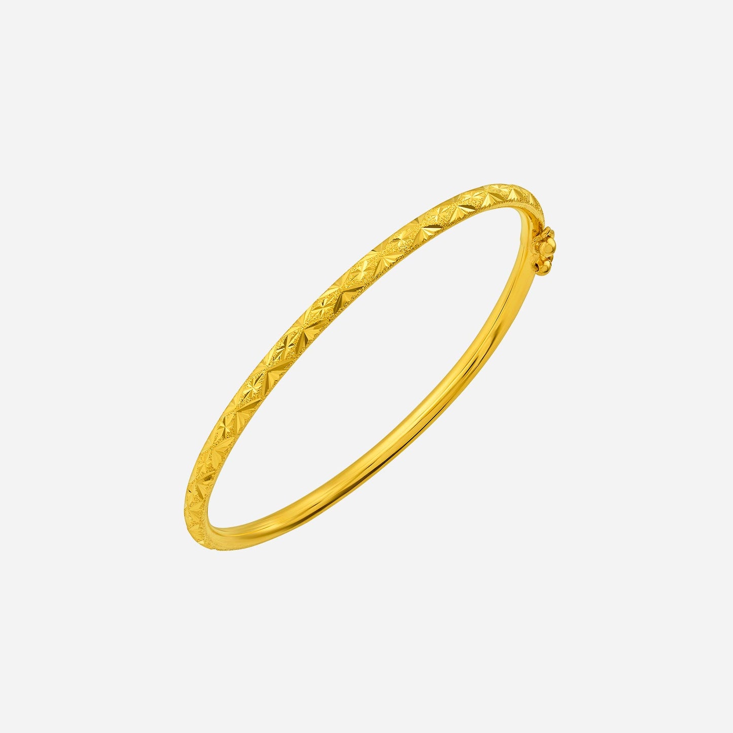 diamond cut bangle in 24k yellow gold with intricate facets reflecting light for a luxurious look.