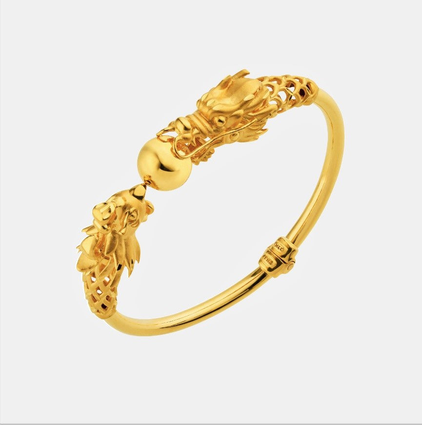 dragon phoenix bangle in shimmering 22k yellow gold featuring intricately designed dragon and phoenix heads.