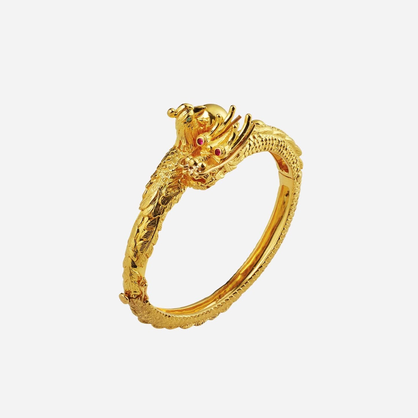 dragon phoenix bangle in intricately designed 22k yellow gold with detailed dragon features and ruby accents.
