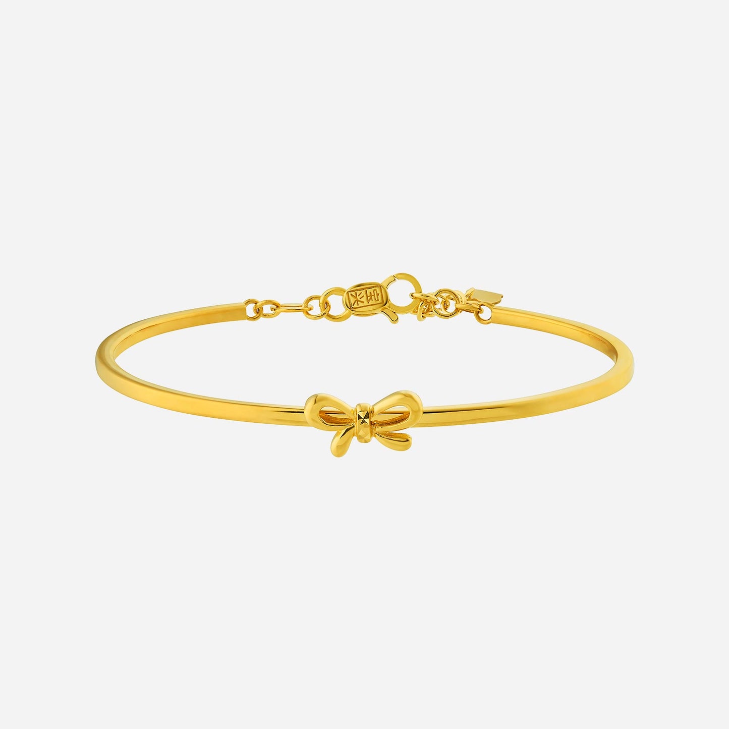22k yellow gold bangle featuring a delicate bow design, perfect for gifting on any occasion.