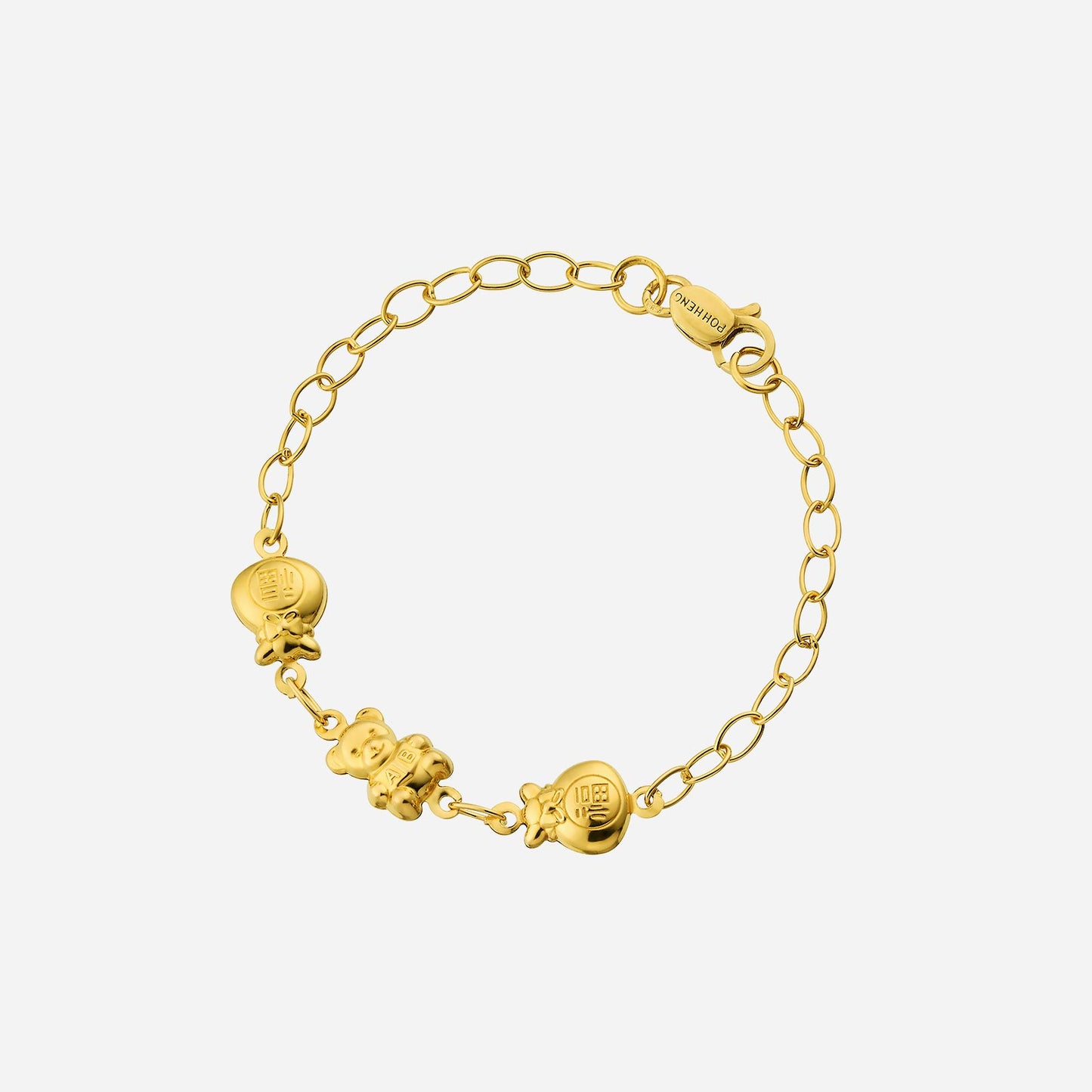 baby charm bracelet in 22k yellow gold featuring a baby bear and two wealth bag charms for prosperity.