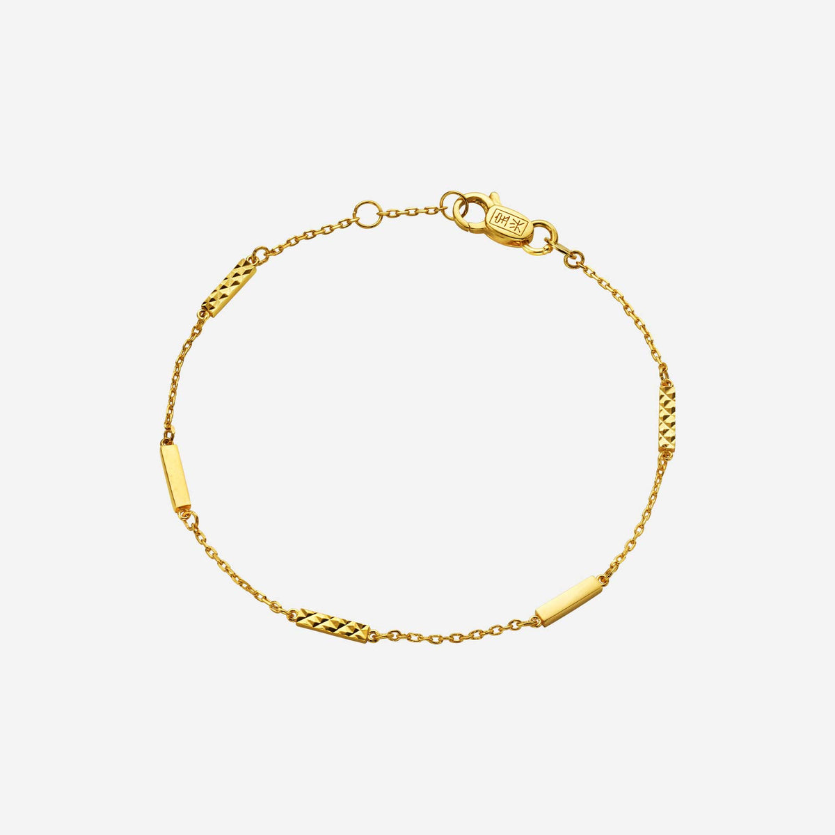 textured bar bracelet crafted from 22k yellow gold with alternate smooth and textured bar details.