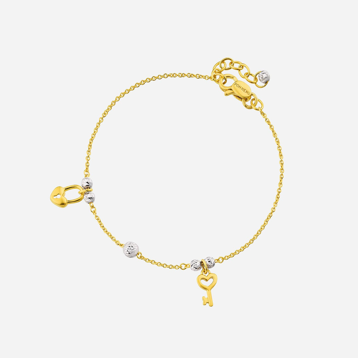key and lock bracelet in 22k yellow white gold with heart lock and key charms; minimalist design with silver beads.