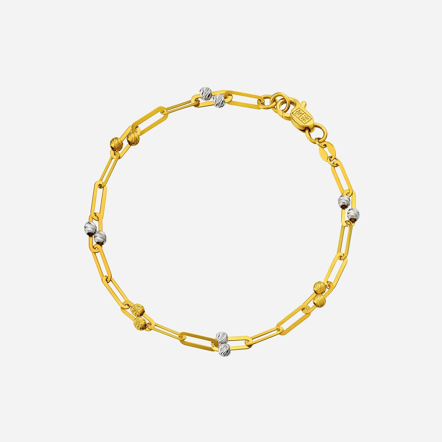 duo-toned bead bracelet in yellow and white gold featuring textured beads and elongated links design.