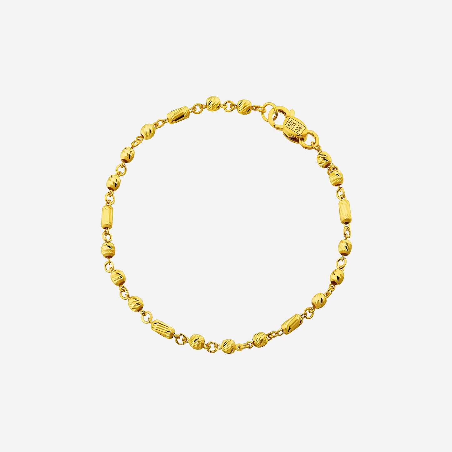 beaded bracelet in 22k yellow gold with a mix of rounded and rectangular patterned beads. perfect for layering.