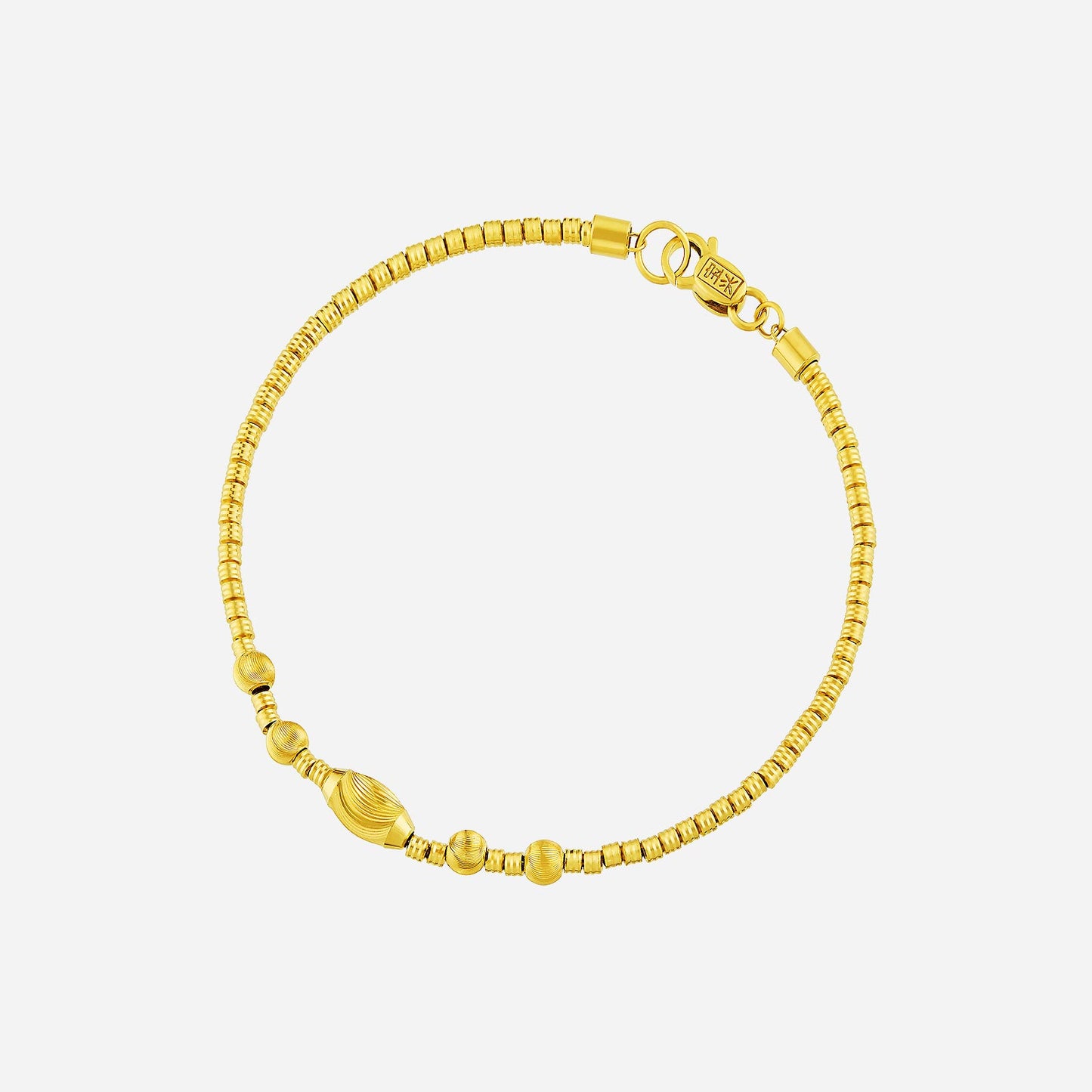 luxe beaded bracelet in 22k yellow gold with uniform spherical beads and textured gold accents. elegant design.