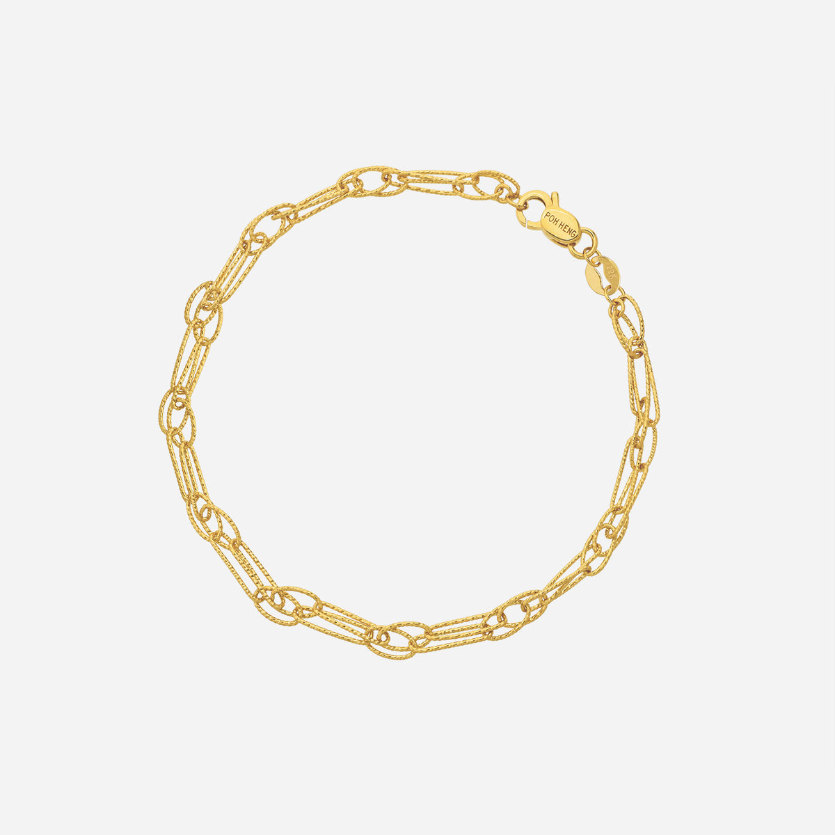 textured loop bracelet in 22k yellow gold with elongated oval links and fine textural detailing. perfect for layering.
