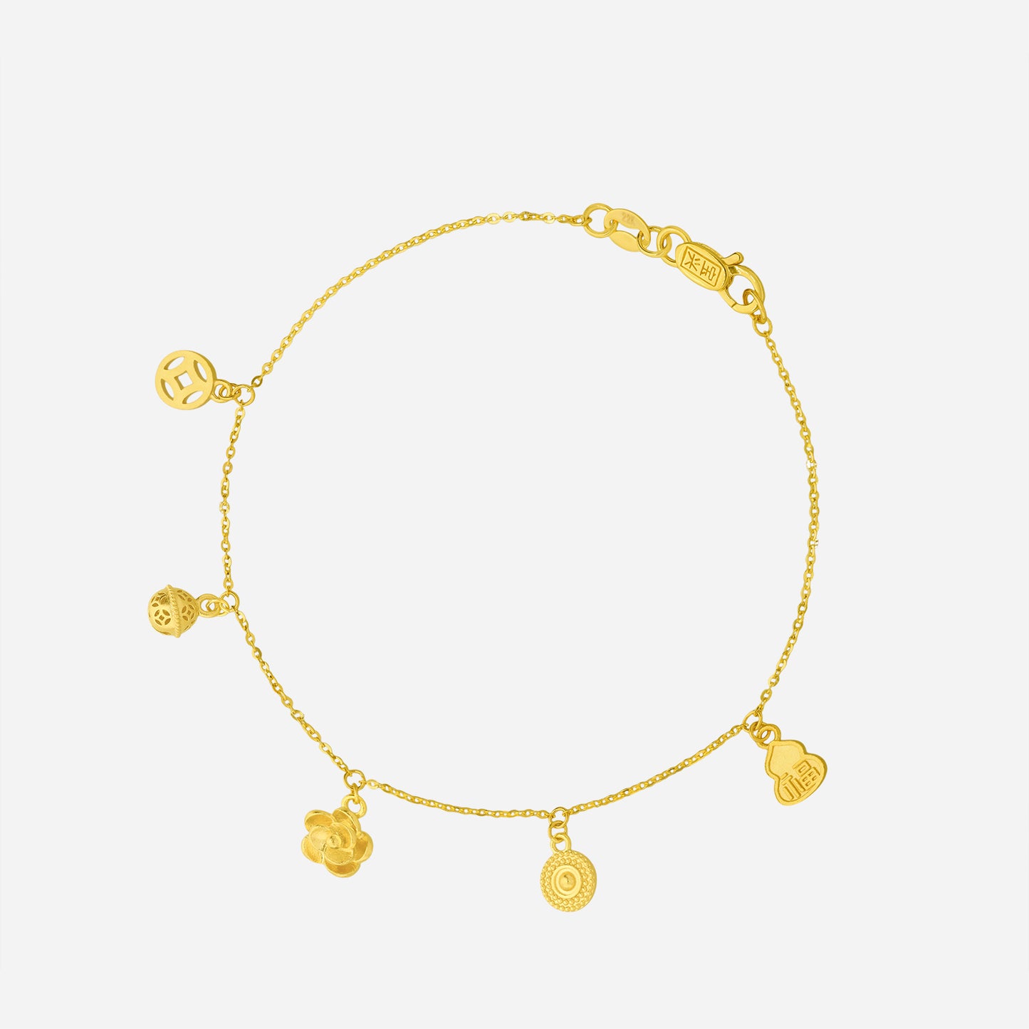 dangling charm bracelet in 22k yellow gold with delicate charms; light and playful design for expressive elegance.