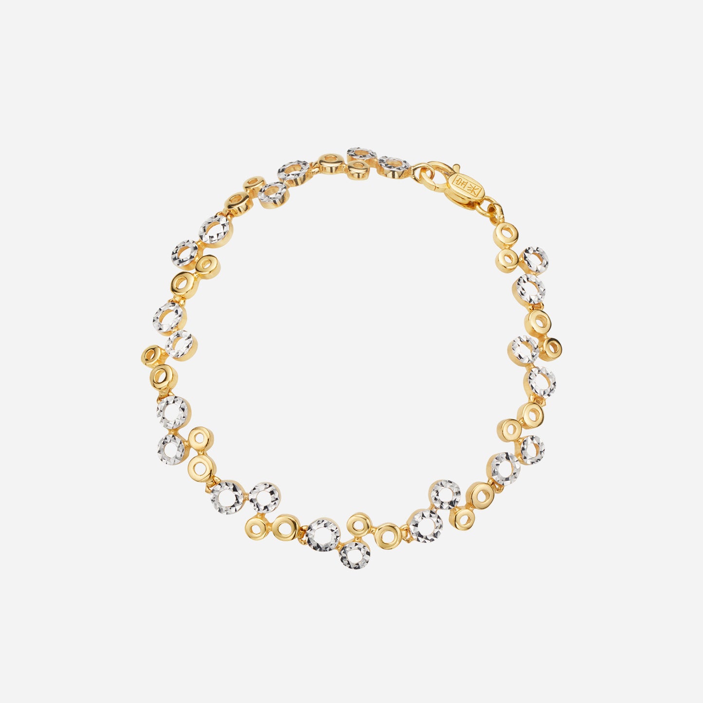 duo tone bracelet made of 22k yellow and white gold featuring flat circular discs and sparkling accents.