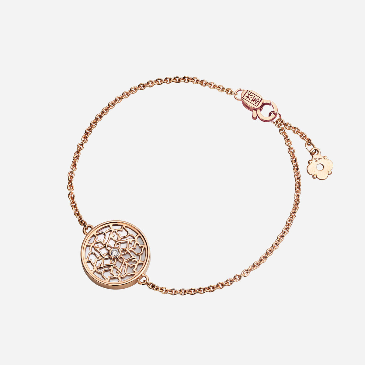 rose gold bracelet featuring a floral motif with mother of pearl and diamond accents on a delicate chain.