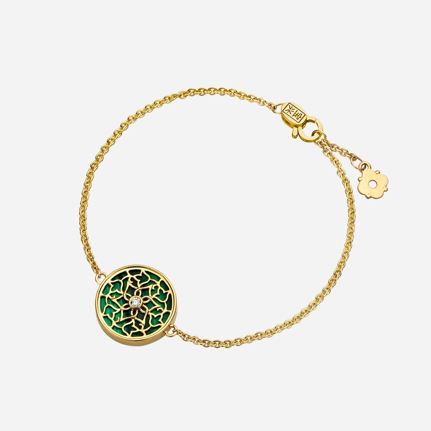 legacy malachite bracelet in 18k yellow gold with intricate floral design and central diamond accent.