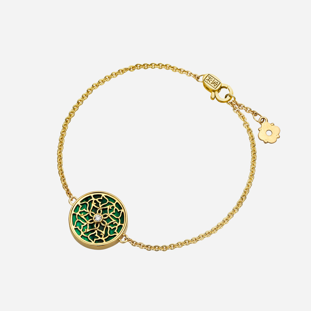 legacy malachite diamond bracelet in 18k yellow gold with intricate floral motif and sparkling diamond accent.
