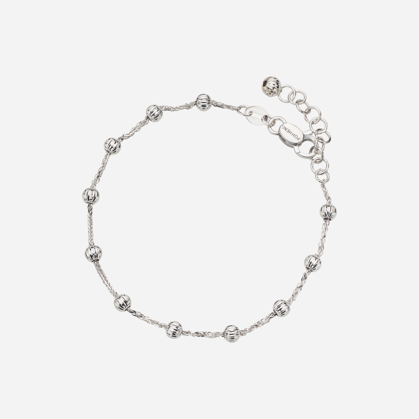 dainty bracelet in 18k white gold featuring decorative spheres along a twisted chain design.