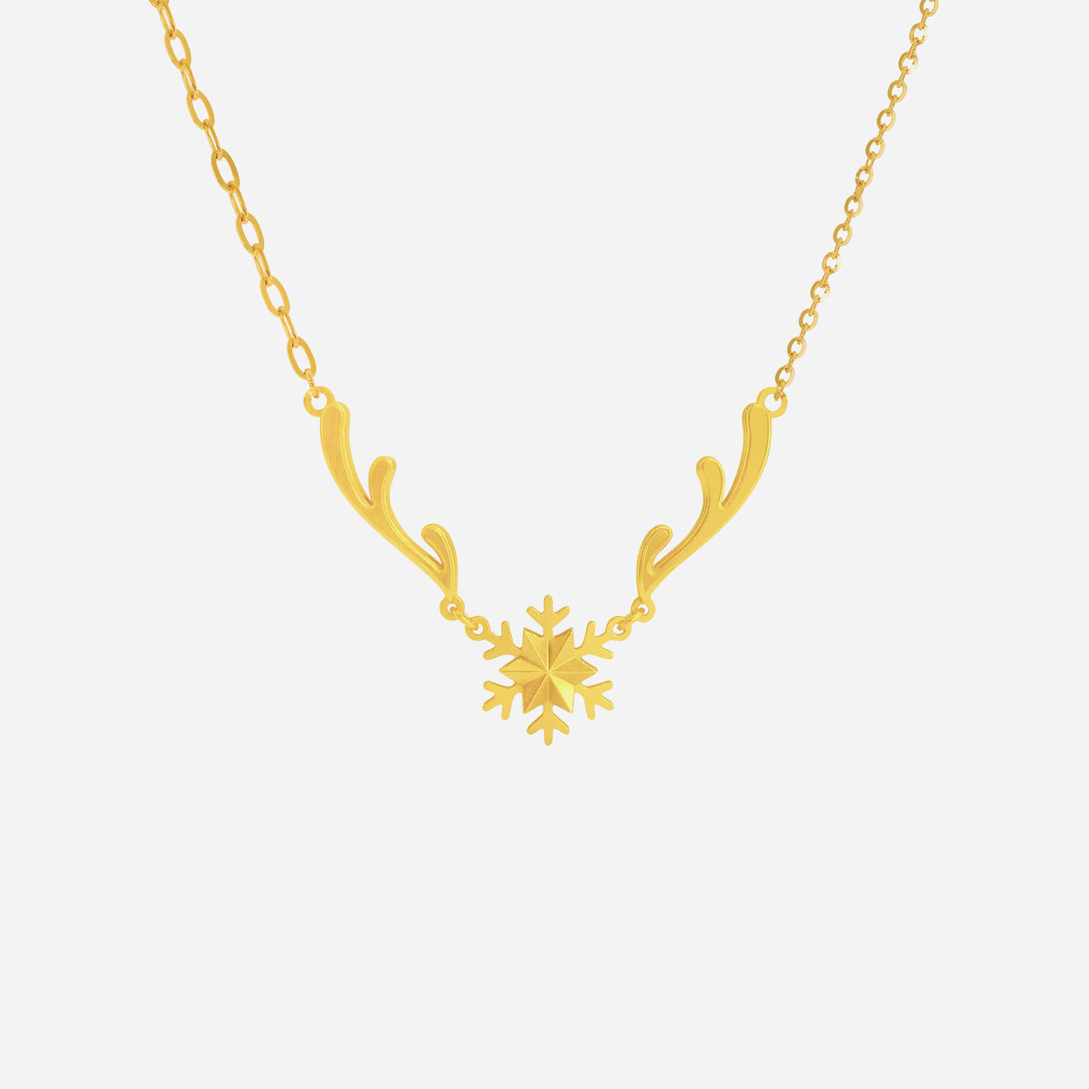 snow crown necklace in 22k yellow gold featuring a snowflake centerpiece and delicate branch accents. elegant and airy design.
