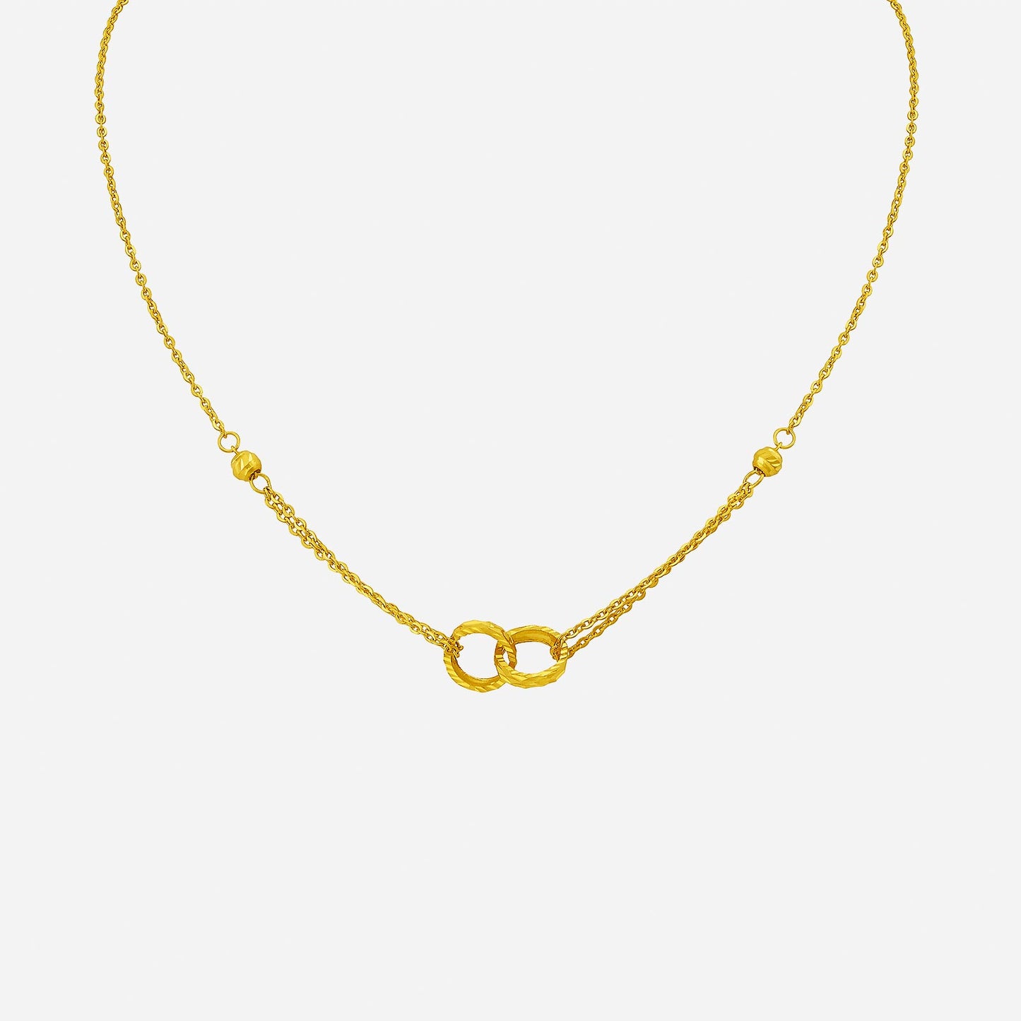 24k yellow gold interlock ring necklace featuring intricately textured rings and a delicate chain design.
