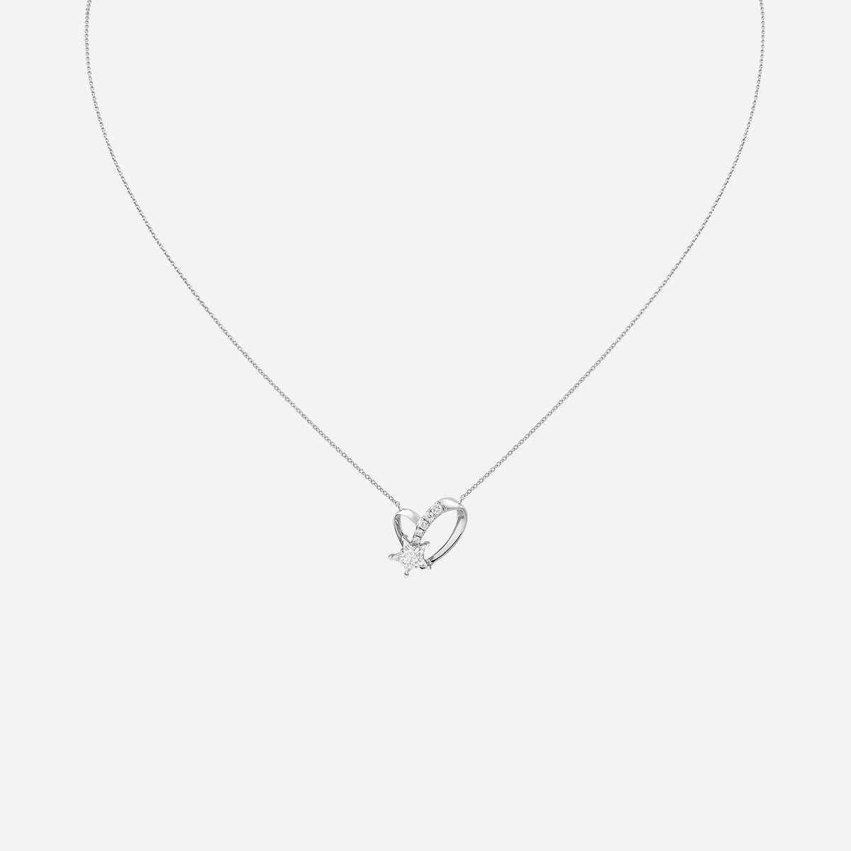 heart-shaped pendant necklace in 18k white gold featuring a diamond star centerpiece and delicate chain design.