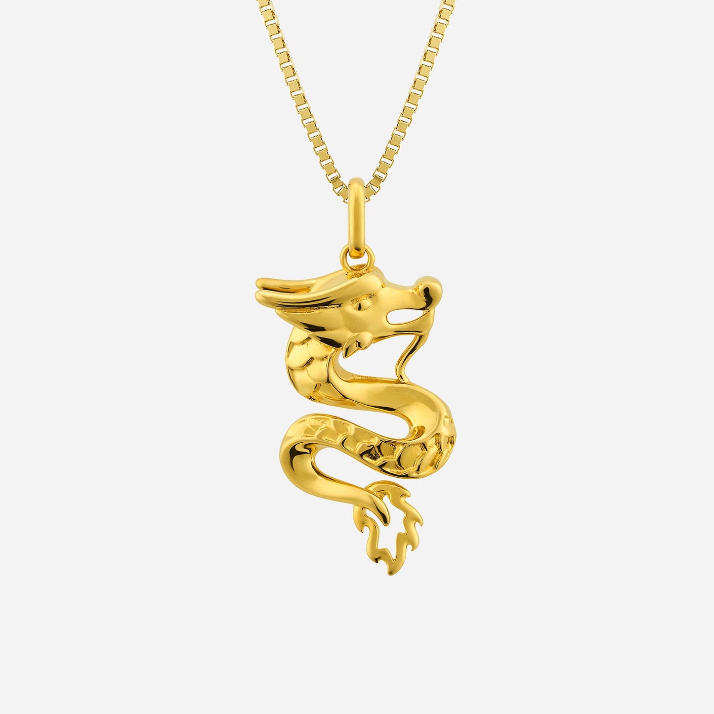 yellow gold dragon pendant with intricate design, symbolizing bravery and dreams, hanging from a delicate chain.