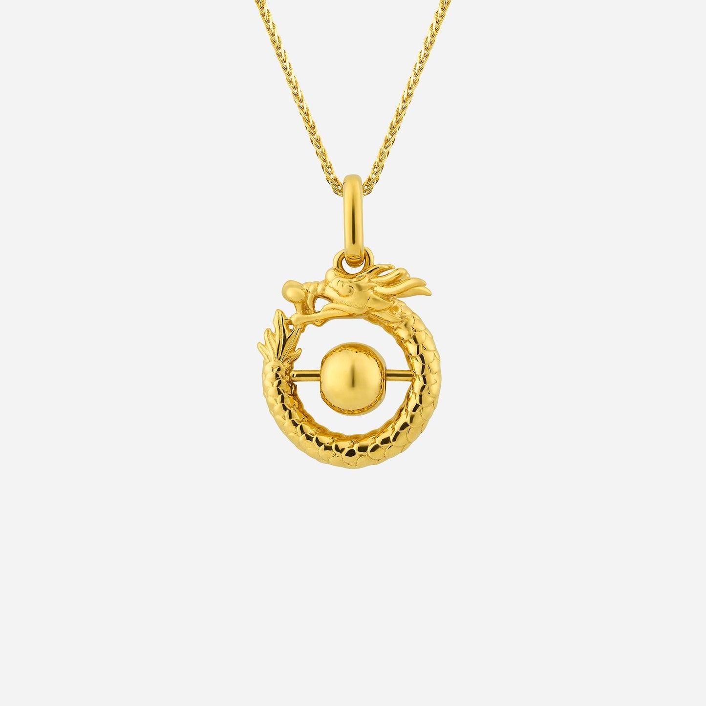 coiling dragon pendant in 22k yellow gold, featuring a rolling bead design, symbolizing wealth and fortune.