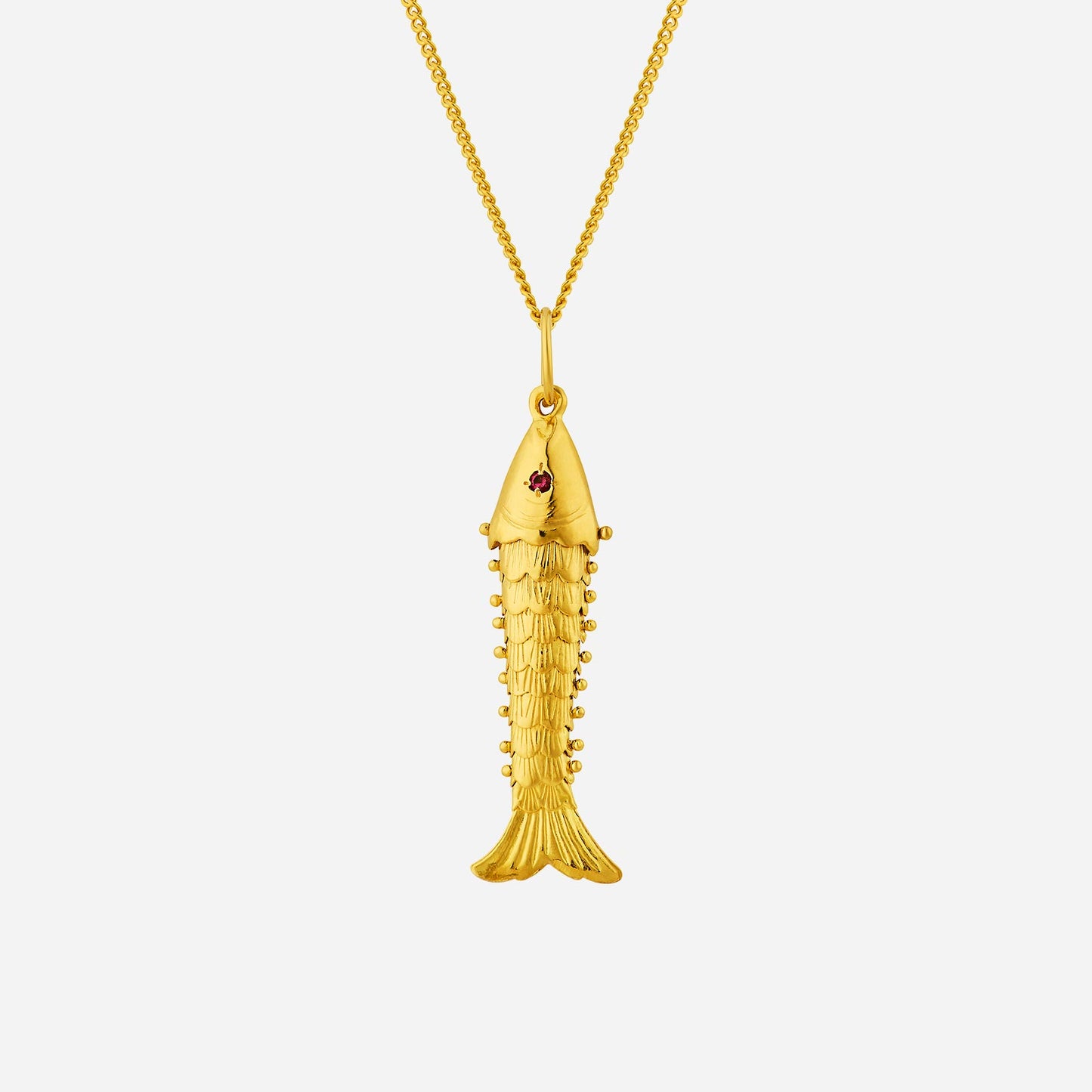 golden fish pendant in 22k yellow gold with intricate design and a small red gemstone accent. elegant and symbolic of prosperity.