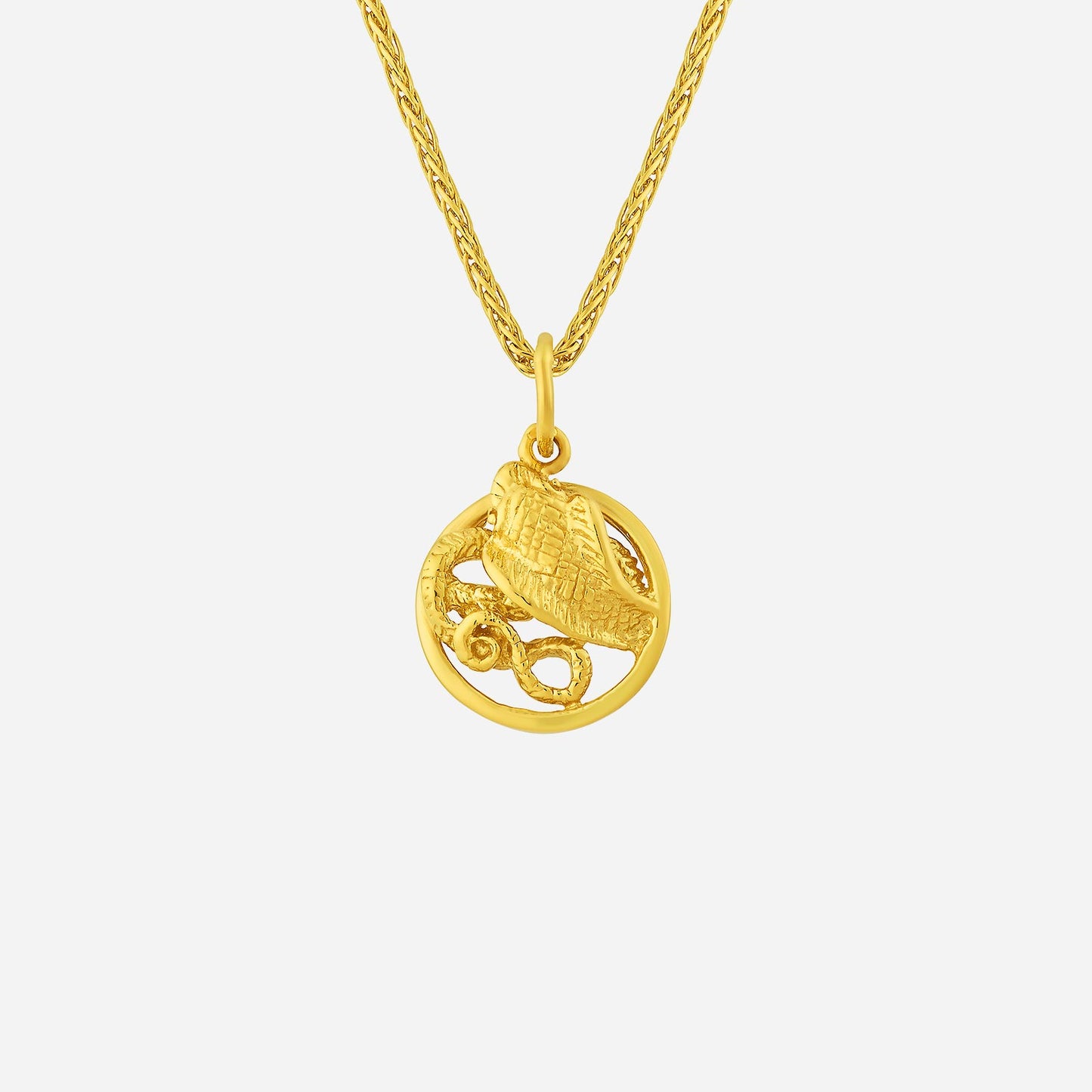 yellow gold snake pendant with intricate serpentine design in a circular frame, showcasing fine details.