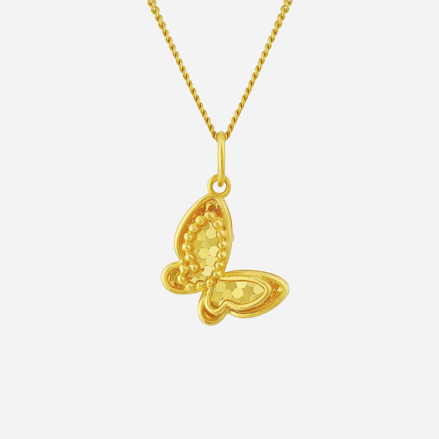 glittering butterfly pendant in 22k yellow gold with sparkling details and textured wings. chain sold separately.
