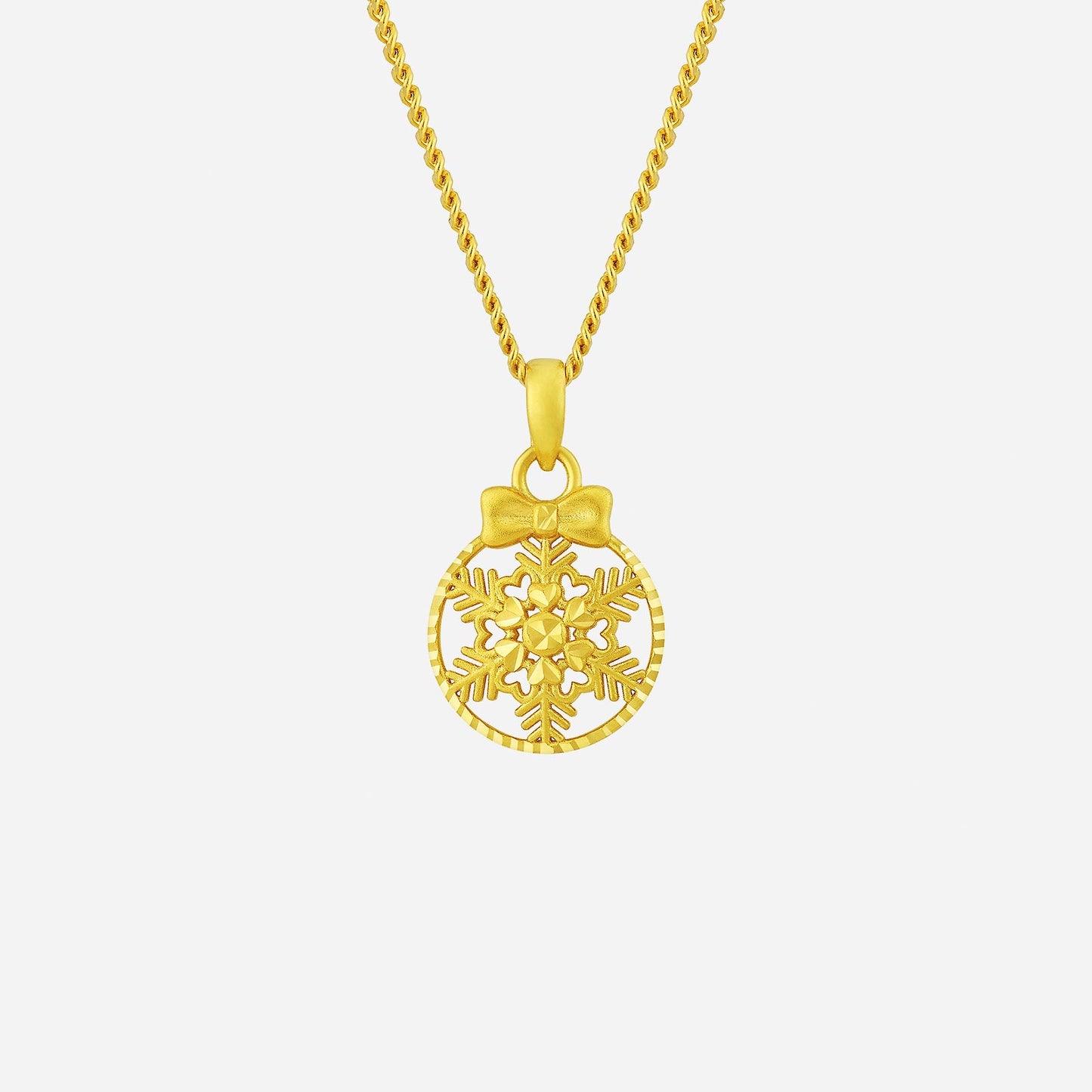22k yellow gold snowflake pendant with bow design, perfect for festive holiday celebrations. chain not included.
