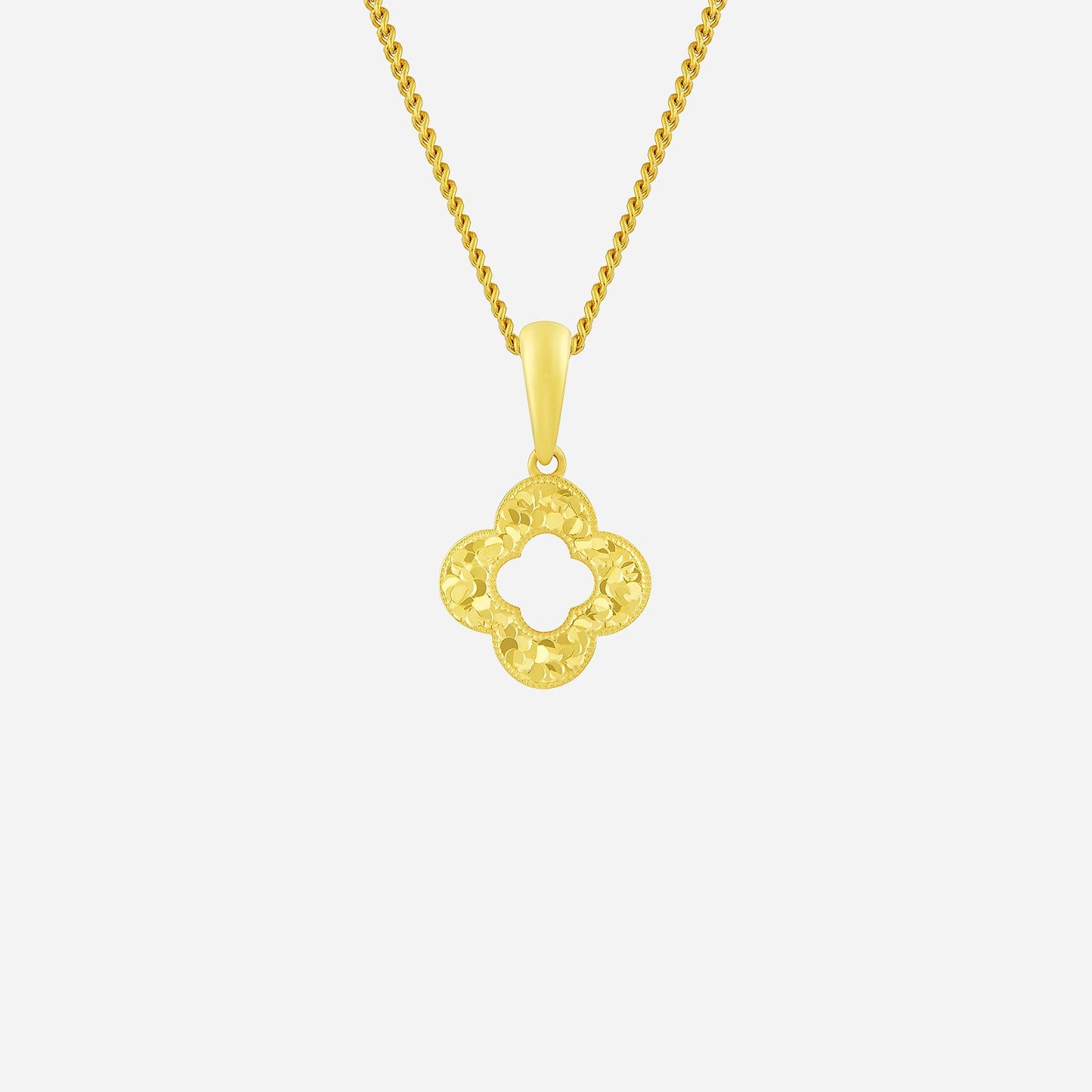 glittering clover pendant in 22k yellow gold with intricate design, perfect for modern elegance and good luck.