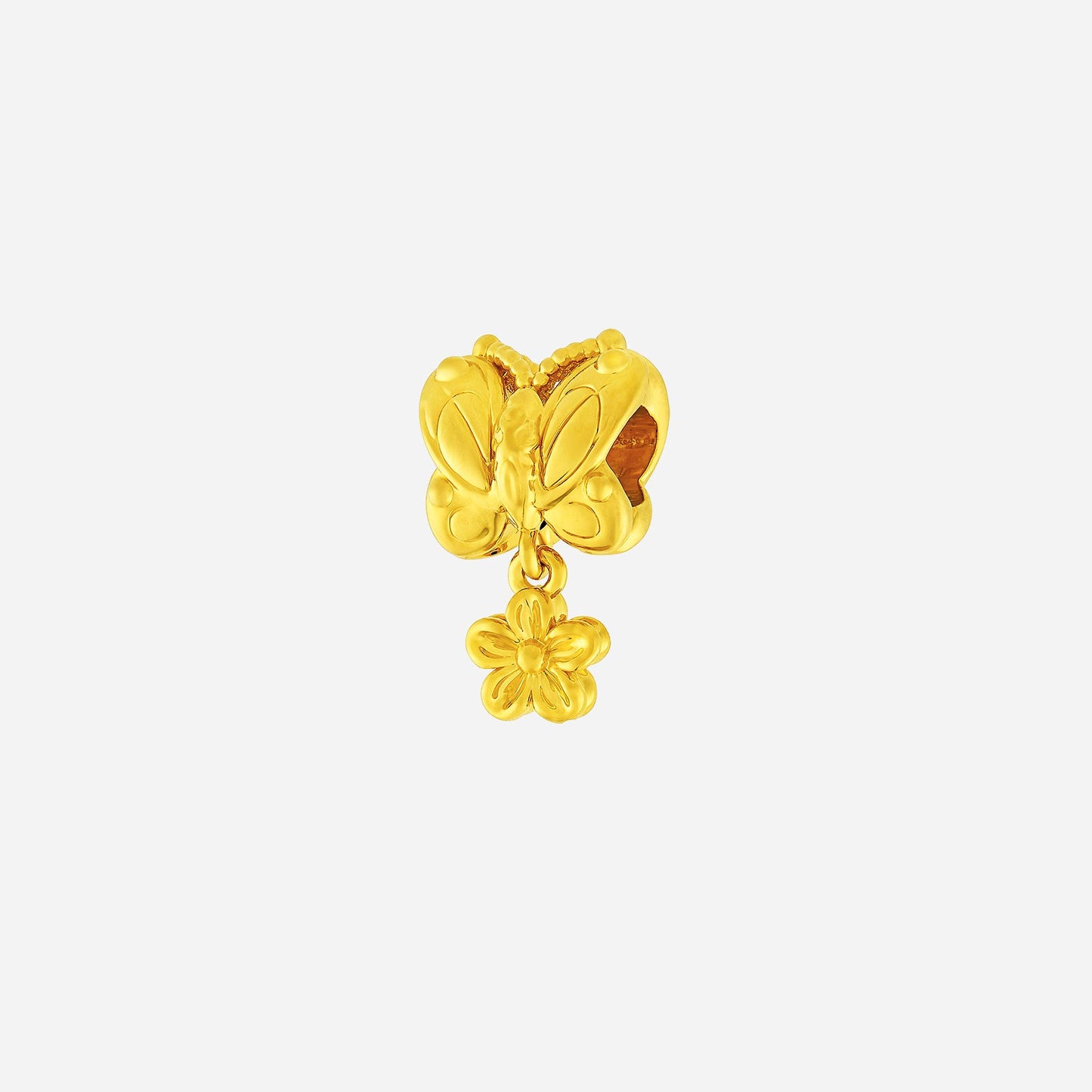 meadow butterfly charm in 22k yellow gold with delicate wings and a small dangling flower accent.