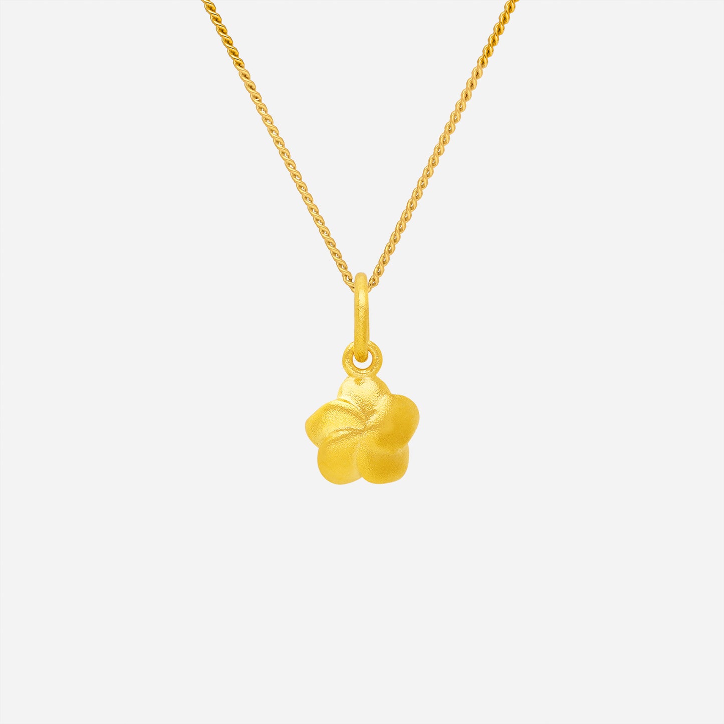 flower pendant in 22k yellow gold featuring a sculpted bloom with graceful curves and warm shine. chain sold separately.