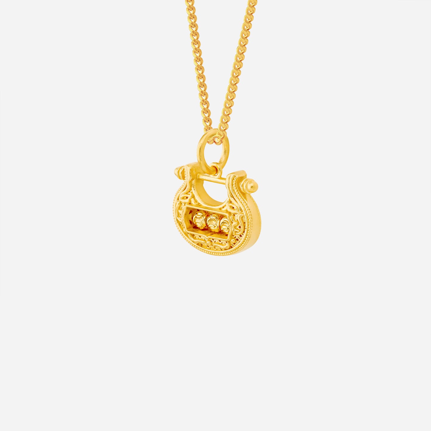 prosperity lock pendant in 22k yellow gold featuring intricate openwork and a trio of spinnable gold beads.